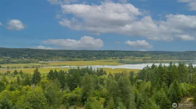 Gorgeous unobstructed view of the lower Hood Canal Basin, framed by the wide open landscapes of the Union River Valley, with forested hills, calm water, and distant ridgelines adding to the scene.