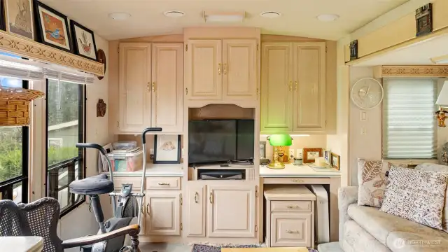 Abundant built-ins provide organized storage for every necessity, while numerous windows fill the space with natural light and create an open, airy feel.