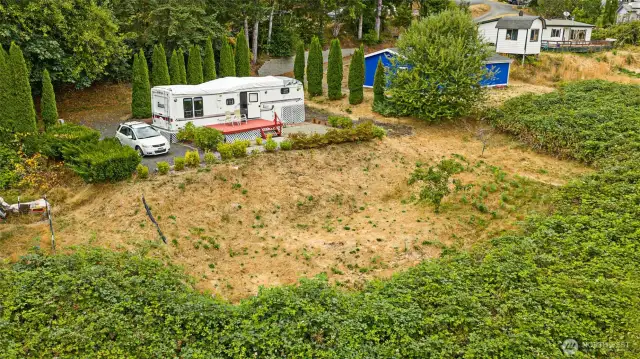 All of the lush greenery in front is part of this lot - and yes, it’s blackberries! Come harvest time, you could be making blackberry pie, simmering jam, or even trying your hand at blackberry wine!