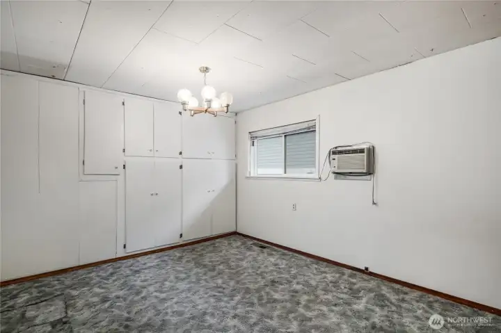Guest bedroom with full wall built in wardrobe closets.