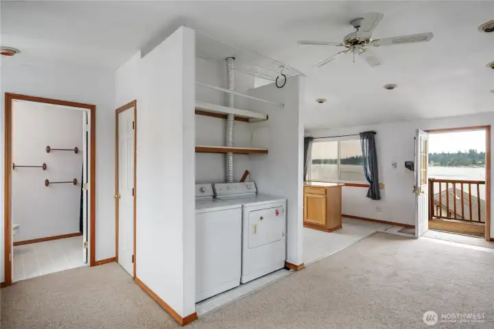 The studio has a phenomenal view from every angle. Showing the open living area, bathroom, laundry area and kitchen.