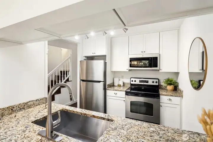 Updated kitchen with granite counters and stainless steel appliances.