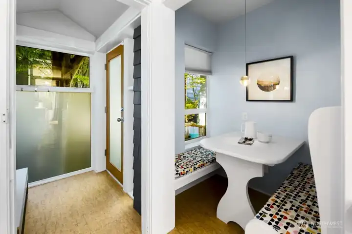 Built-in breakfast booth by the side entry, frosted glass preserves privacy while filtering light.