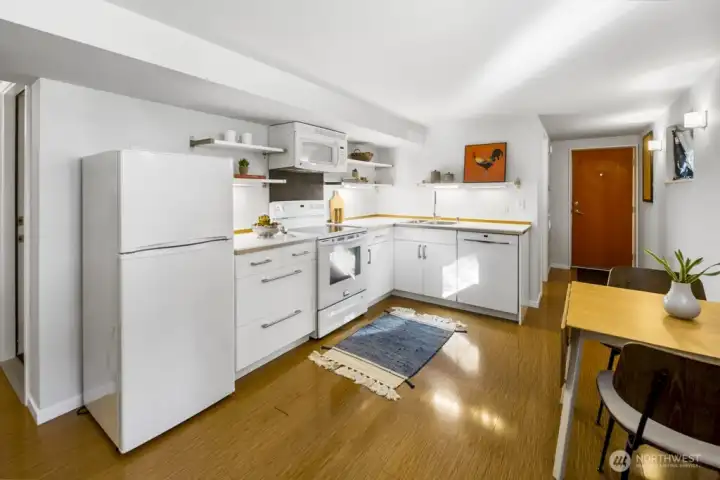Lower-level studio kitchen with full-size appliances and generous counter space for meal prep.