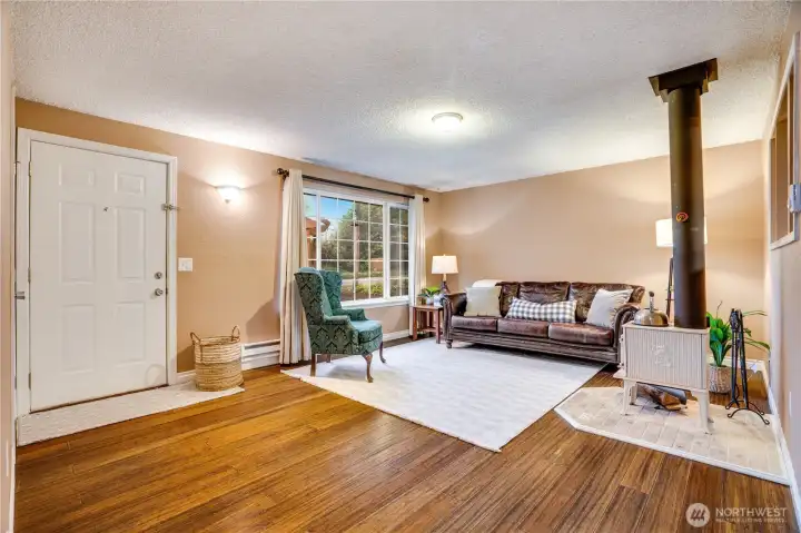 Warm hardwood floors and abundant natural light make this living room a welcoming centerpiece. Let's check out the rest of the house.