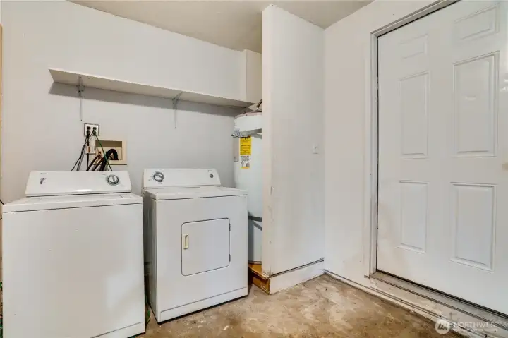 The attached garage includes a washer and dryer, attic storage, and a handy workbench for projects.