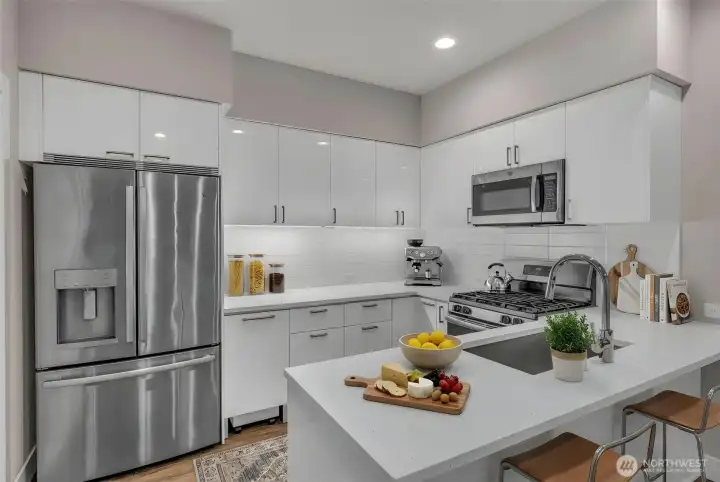 (Virtually Staged) Kitchen with quartz countertops, stainless steel appliances, and custom cabinet organizers