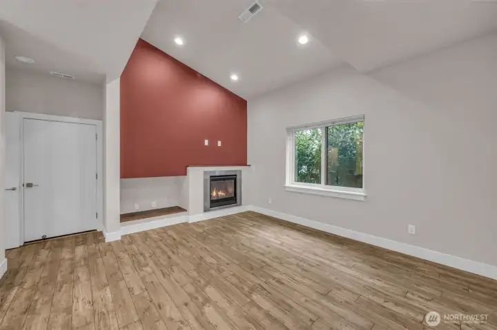 Living room with high ceilings and cozy gas fireplace.