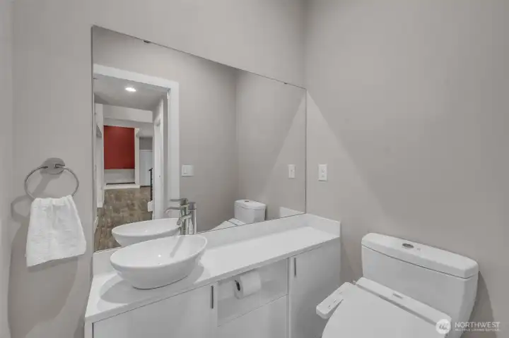Main floor deluxe powder room off entry has heated seat and bidet