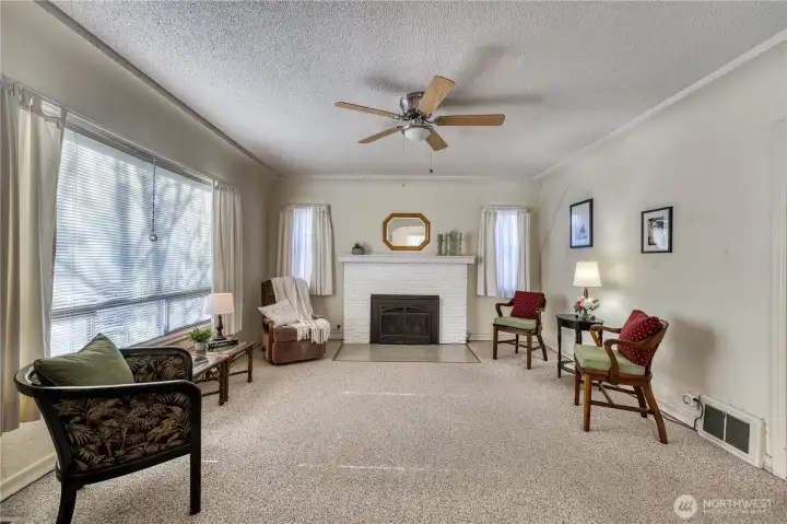 Large window for warmth and light and coved ceilings brings old world charm.  Possible hardwood floors under carpet on the main floor.