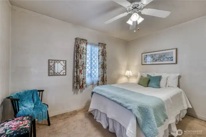 Main floor bedroom has walk in closet and door to the back yard.