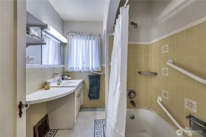 Vintage bathroom is a timeless classic.  Tile mosaics on the floor with tile walls as well.
