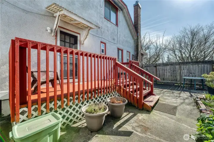 Deck off back to fully fenced patio.