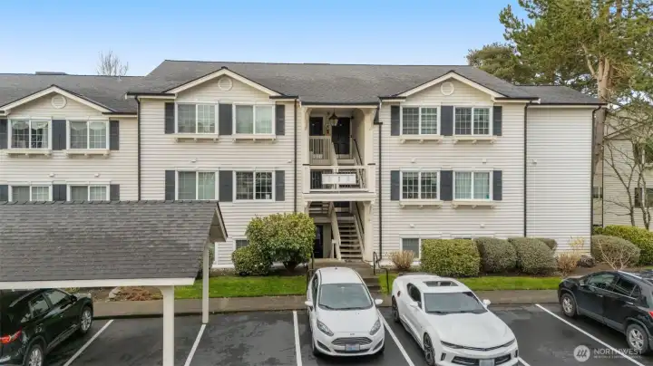Unit is down the stairs on the left and the empty parking space on the right comes with the unit