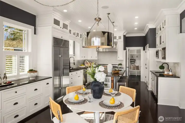 Spacious chefs kitchen with all high-end appliances and granite slabs.