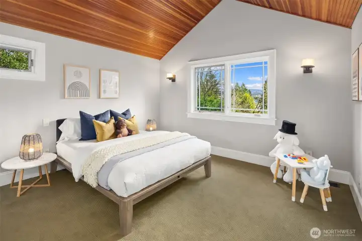 Bedroom with water views and bead board ceiling.