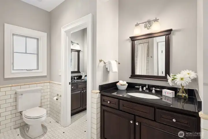 Jack n Jill bathroom (with tub) between the 2 bedrooms and includes 2 sink areas.
