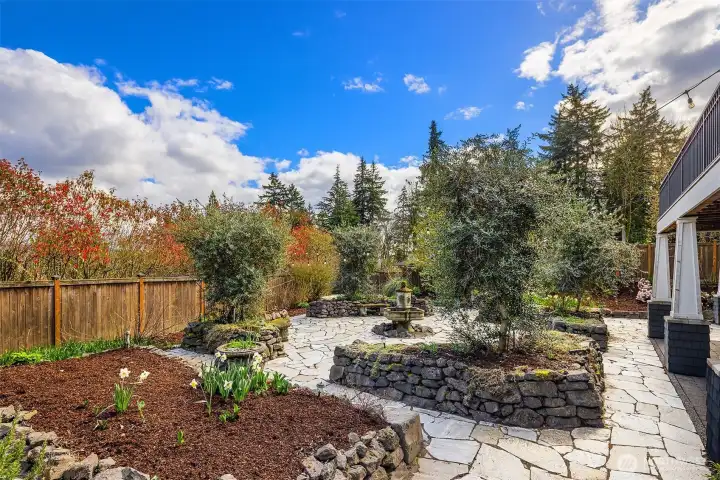 European style back yard with extensive stonework and fountain.