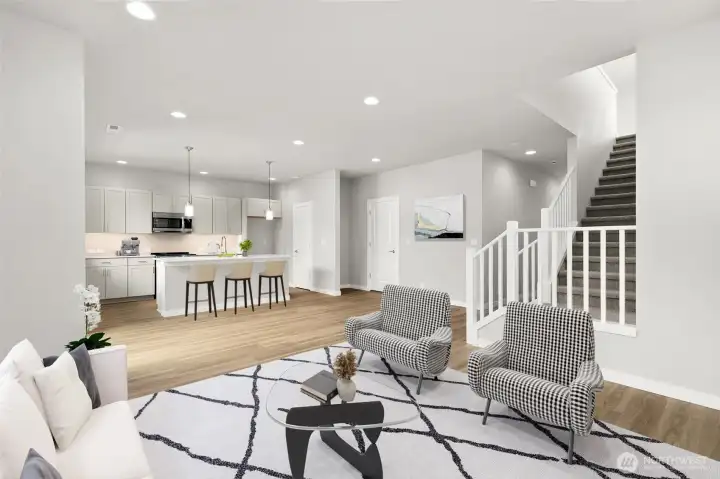 Open concept with living room and kitchen with walk-in pantry. Virtually staged.