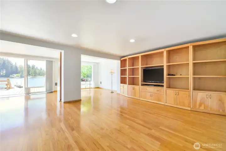 The large living room with built-ins and hardwood floors.