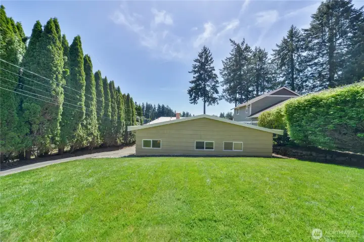A view of the back of the garage and bonus room from the house.