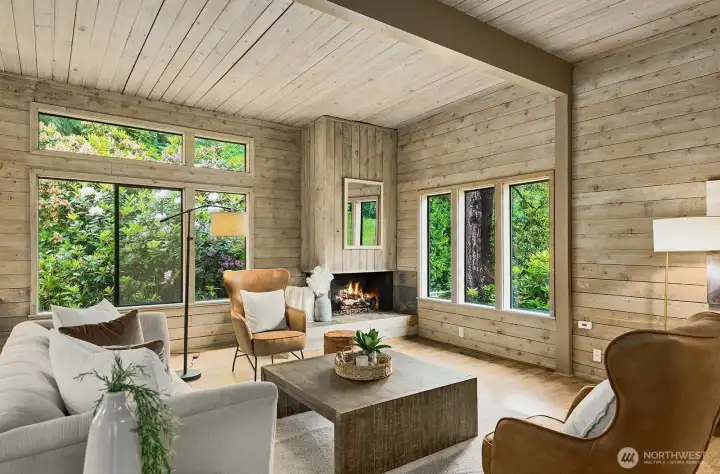 Open concept great room with gas fireplace and lots of windows