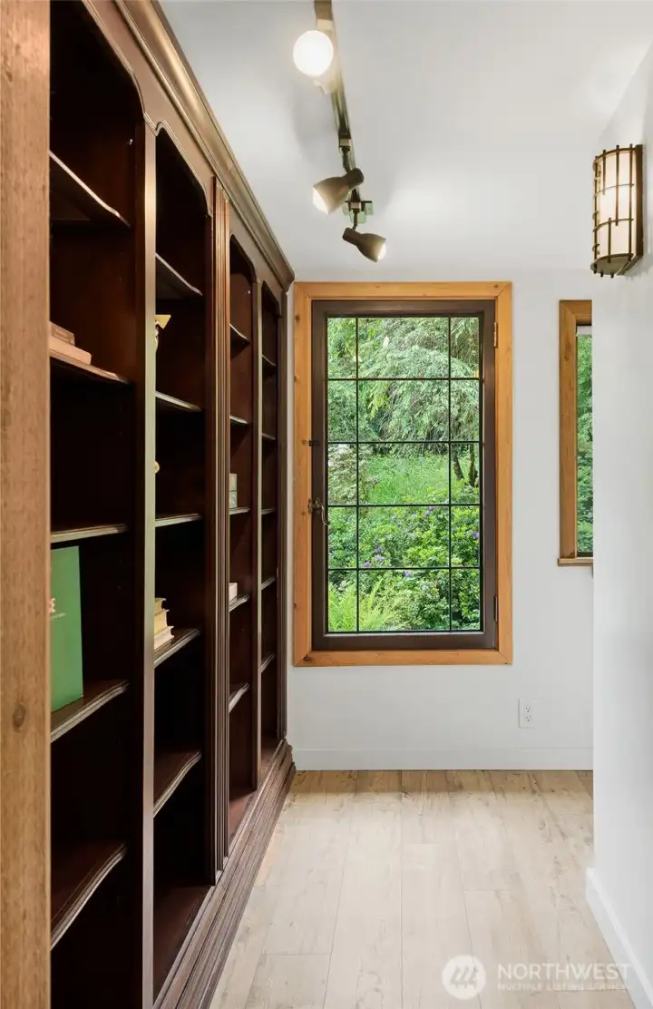 At the end of the hall you will find built-in book shelves and study area to the right