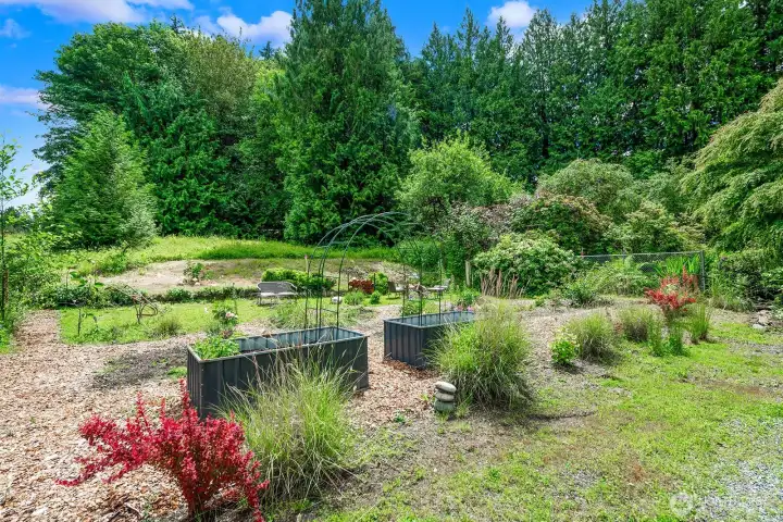 Want to garden your own herbs - you can in these two raised garden tubs.  Property line goes straight back to black chain link fence.