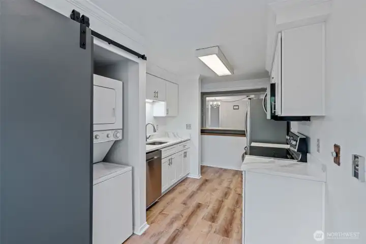 Pantry space, water heater, washer & dryer concealed behind barn door.