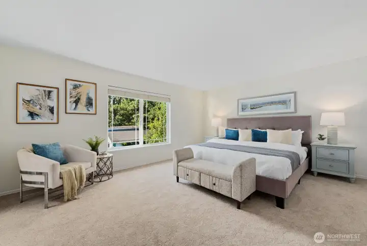Ahhh - the spacious primary bedroom can accommodate so much!