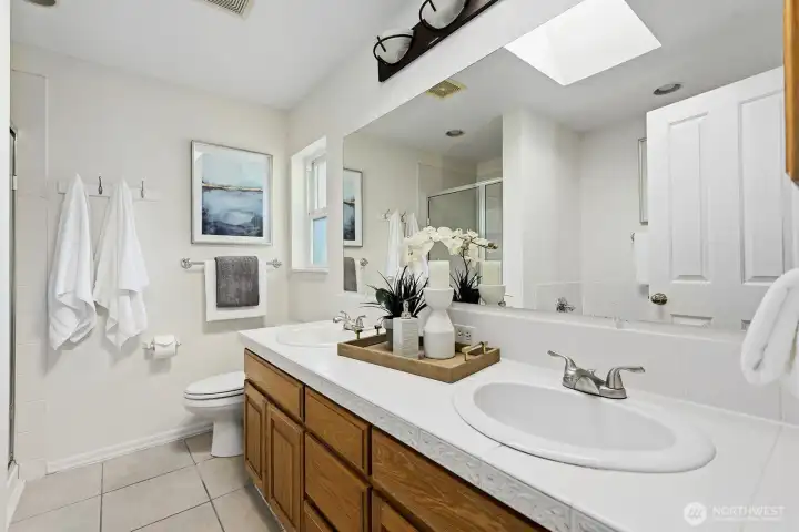 Primary bath with dual sinks and skylight!