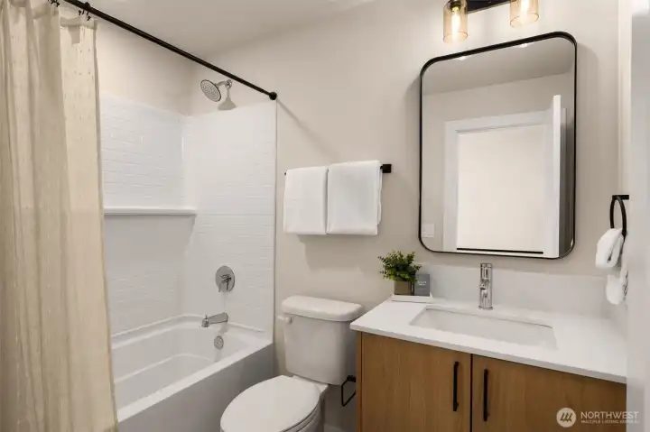 Stylish full bathroom featuring a clean white vanity, contemporary finishes, and a tub/shower combo (these are of model home, similar finishes and layout) Stylish full bathroom featuring a clean white vanity, contemporary finishes, and a tub/shower combo (these are of model home, similar finishes and layout)