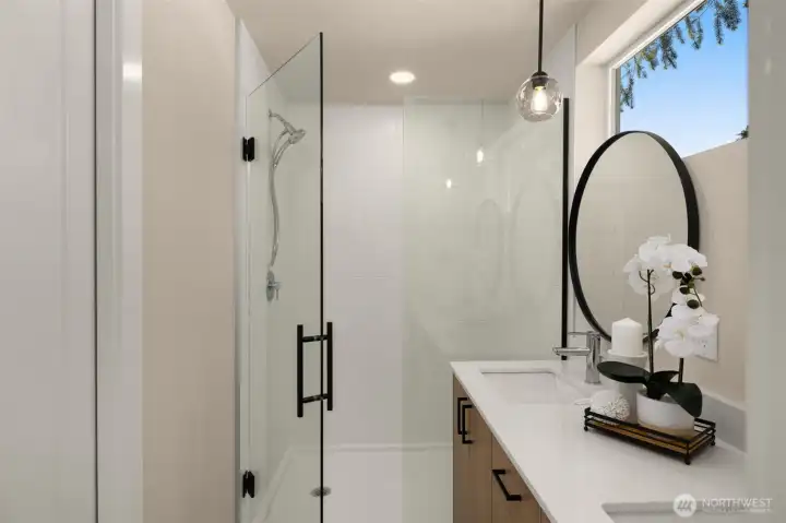 Sleek modern primary en-suite bathroom boasting premium fixtures and a spacious glass-enclosed shower (these are of model home, similar finishes and layout) Sleek modern primary en-suite bathroom boasting premium fixtures and a spacious glass-enclosed shower (these are of model home, similar finishes and layout)