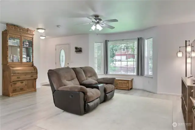 As you enter the home, you will find a lovely living room with beautiful easy-care flooring and love the large bay window!