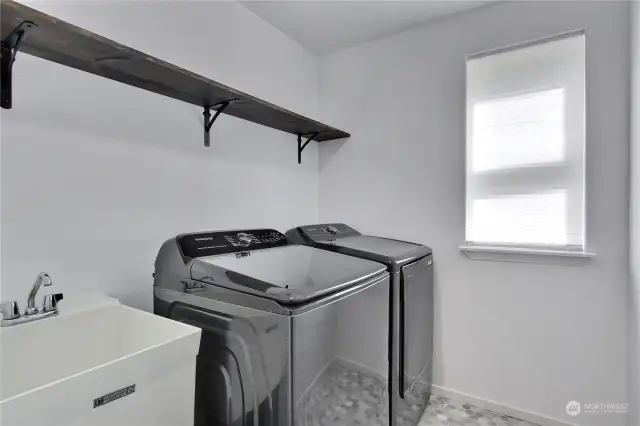 Your utility room with handy sink, window and storage shelving.