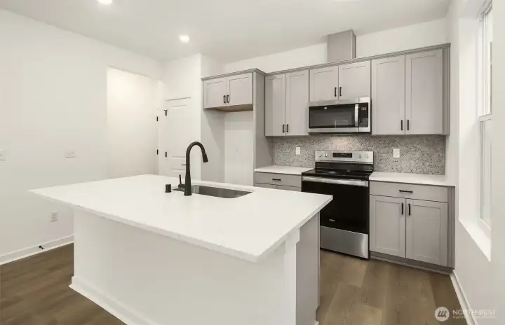 Kitchen with gray "penny tile" back splash