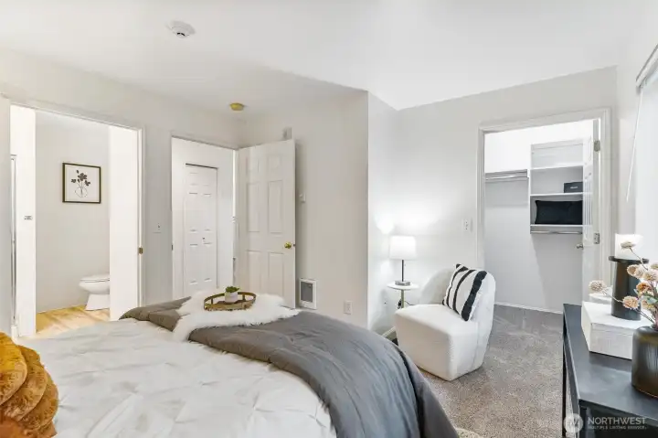 The primary suite offers a tranquil retreat with generous space and plush carpeting,