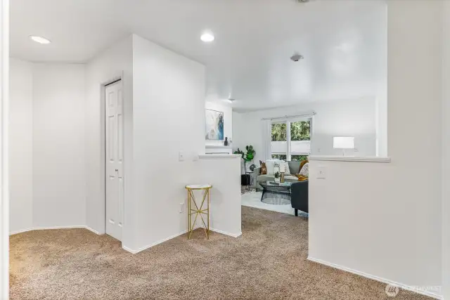 Open and airy hallway leading to the kitchen and living spaces.
