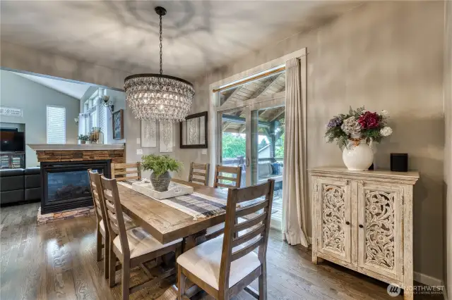 Another view of the dining room. Notice the two-sided fireplace and the beautiful smoked glass chandelier.
