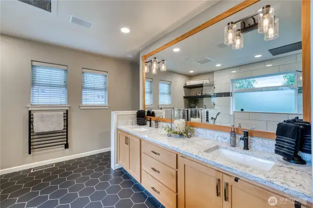 Dual vanities, wood wrapped mirror and the added luxury of a heated towel rack.