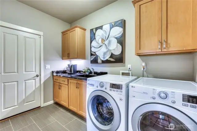 Laundry room is spacious with lots of cabinets.  Washer and dryer stay with the home.