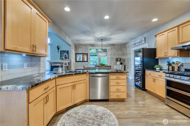 Kitchen with stainless appliances has nice flow to the dining room and family room.