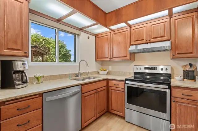 Stainless Appliances, a Beverage Cooler, Quartz Counters some soft close cabinets were added & soft work lighting creates a Great cooking environment for the chef.