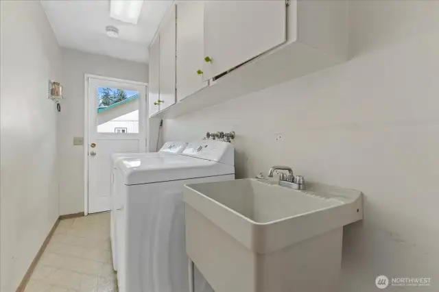 A large Laundry room with cabinetry to stay organized.
