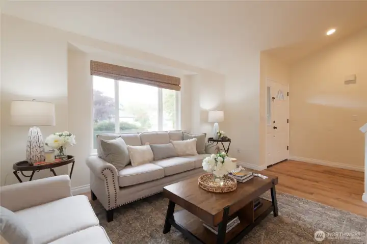 The welcoming entryway immediately sets the tone with light-filled space and vaulted ceilings above the living room. It’s the perfect first impression for guests and homeowners alike.