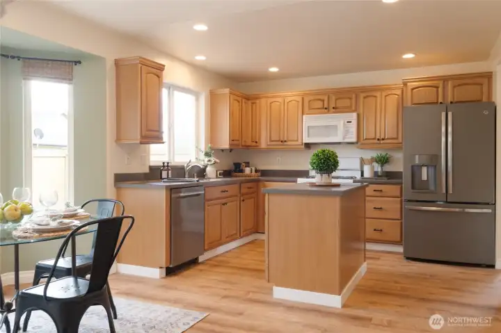The kitchen flows seamlessly to the sunny eating nook and family room ensuring that everyone stays connected—whether cooking, dining, or relaxing by the fire. Perfect for both everyday living and entertaining, this layout creates a natural gathering place or area to relax.