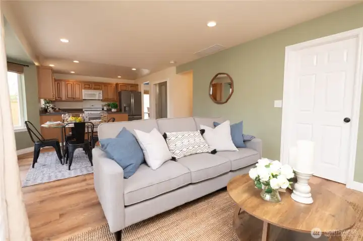 View back to the kitchen eating nook, walk in pantry and kitchen. Door to the laundry room then out to the garage conveniently located at right of photo.
