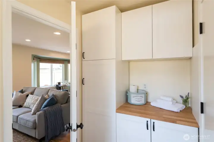 Main floor laundry room with Washer/Dryer hookup and plenty of storage! Even a place to fold your laundry.