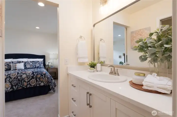 This custom cabinetry offers generous storage and a ton of counter space for your personal items. Fully rounded out with a large, walk in closet and W/C.