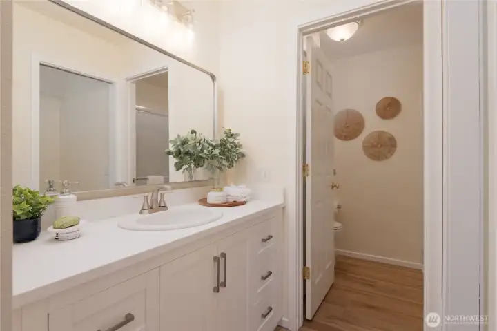 The beautifully updated Primary EnSuite enjoys custom cabinetry, a walk-in closet, separate W/C and easy care LVP flooring.